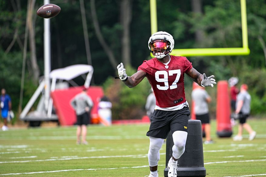 Washington Commanders defensive tackle Efe Obada (97) can’t secure the football during the second day of training camp at the OrthoVirginia Training Center at Commanders Park in Ashburn, Virginia, July 27, 2023. (Photo by Brian Murphy)
