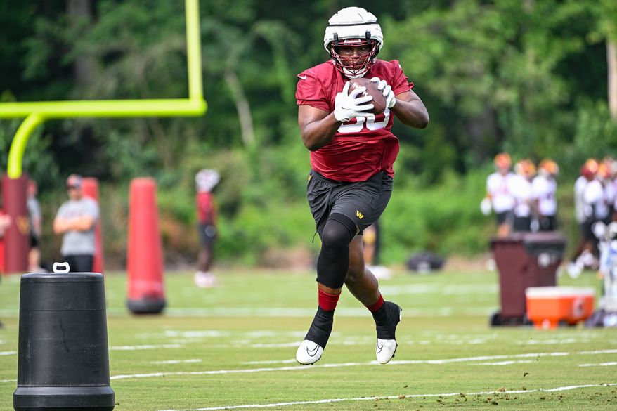 Washington Commanders defensive tackle Phidarian Mathis (98) catches the football during the second day of training camp at the OrthoVirginia Training Center at Commanders Park in Ashburn, Virginia, July 27, 2023. (Photo by Brian Murphy)