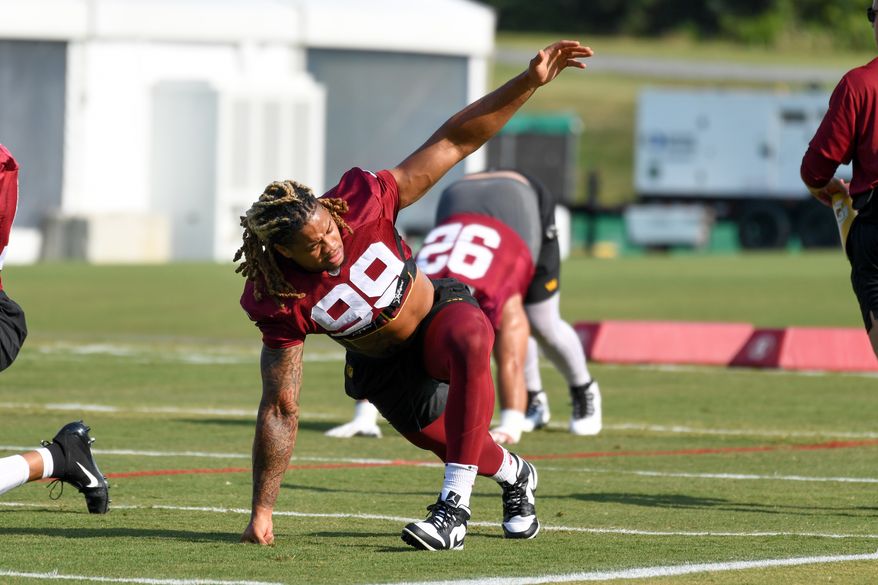 Washington Commanders defensive end Chase Young (99) doing stretching exercises during the third day of training camp at the OrthoVirginia Training Center at Commanders Park in Ashburn, Virginia, July 29, 2023. (Photo by Billy Sabatini)