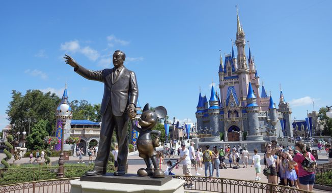 Park guests stroll past the statue of Walt Disney and Mickey Mouse in the Magic Kingdom at Walt Disney World Friday, July 14, 2023, in Lake Buena Vista, Fla. Disney is asking a Florida judge to toss out a lawsuit filed by Gov. Ron DeSantis&#x27; appointees to Disney World&#x27;s governing district. (AP Photo/John Raoux)