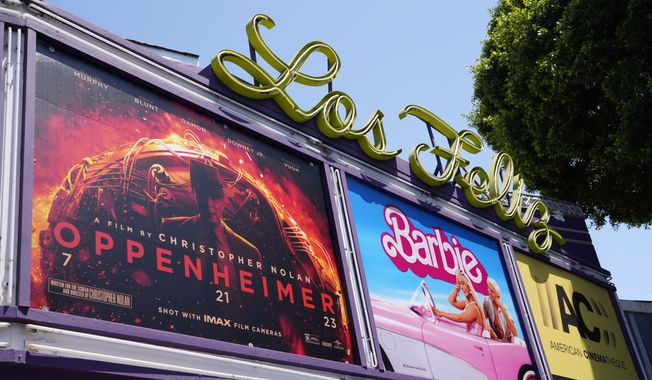 The marquee for the Los Feliz Theatre features the films &quot;Oppenheimer&quot; and &quot;Barbie,&quot; Friday, July 28, 2023, in Los Angeles. (AP Photo/Chris Pizzello)