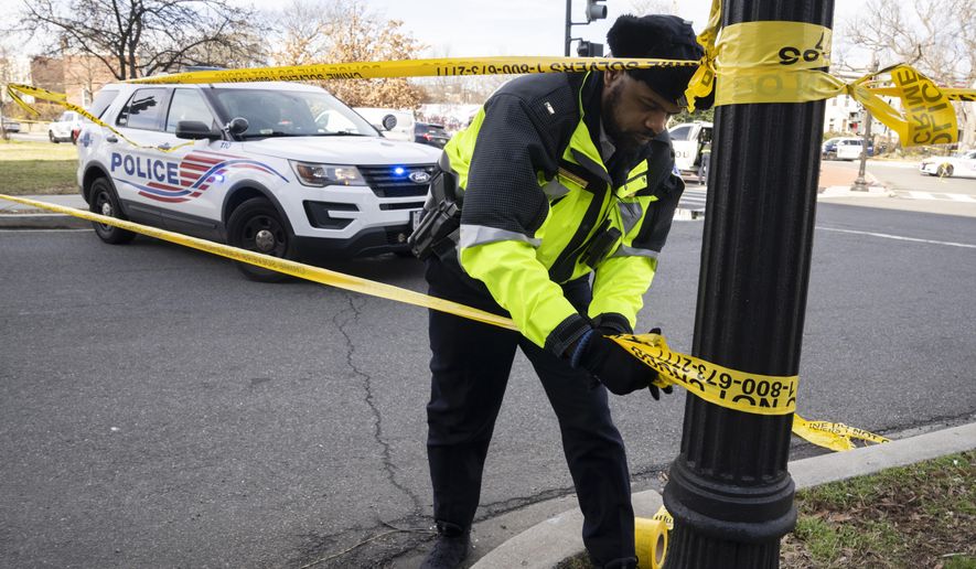 A Washington Metropolitan Police officer, puts yellow tape around the Potomac Avenue Metro Station in Southeast Washington, Feb. 1, 2023. District of Columbia Mayor Muriel Bowser&#x27;s government has been struggling to handle steadily rising violent crime rates in recent years. Although police and city officials point out that overall crime rates have stayed steady, murders and carjackings have spiked — stoking public anxiety. (AP Photo/Manuel Balce Ceneta, File)