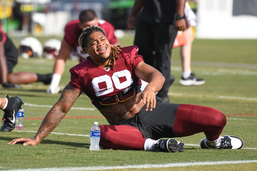 Washington Commanders defensive end Chase Young (99) taking part in stretching exercises during the fourth day of training camp at the OrthoVirginia Training Center at Commanders Park in Ashburn, Virginia, July 29, 2023. (Photo by Billy Sabatini)