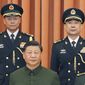 In this photo released by Xinhua News Agency, Chinese President Xi Jinping, also chairman of the Central Military Commission (CMC), center, poses for photos with the new commander of the rocket force Wang Houbin, top left, and its political commissar Xu Xisheng, top right, after promoting them to the rank of general in Beijing on Monday, July 31, 2023. (Li Gang/Xinhua via AP)