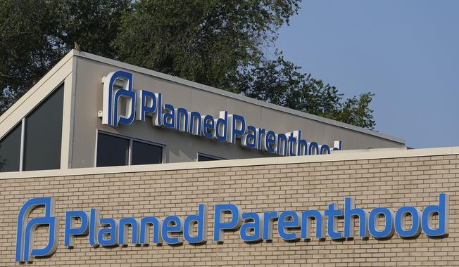 A Planned Parenthood sign is displayed on the outside of a clinic during a news conference, Tuesday, Aug. 1, 2023, in Indianapolis. (AP Photo/Darron Cummings)