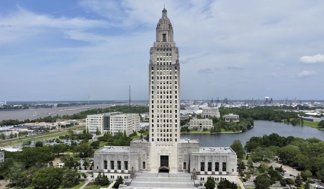 The Louisiana state Capitol stands prominently, April 4, 2023, in Baton Rouge, La. A slew of new Louisiana laws, recently passed by the Republican-dominated Legislature and signed by Democratic Gov. John Bel Edwards, went into effect Tuesday, Aug. 1. Among the new laws are ones that increase punishments for fentanyl-related crimes, a requirement that every public school classroom display the phrase “In God We Trust,” and an addition to the state’s age verification law to access pornography websites. (AP Photo/Stephen Smith, File)