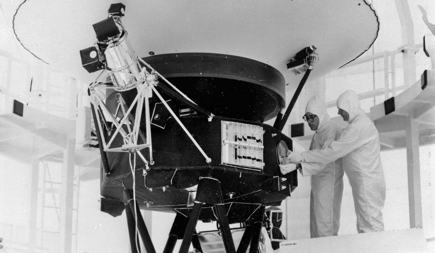 In this Aug. 4, 1977, photo provided by NASA, the "Sounds of Earth" record is mounted on the Voyager 2 spacecraft in the Safe-1 Building at the Kennedy Space Center, Fla., prior to encapsulation in the protective shroud. After days of silence, NASA has heard from Voyager 2, more than 12 billion miles away in interstellar space. Flight controllers accidentally sent a wrong command nearly two weeks ago that tilted the spacecraft's antenna away from Earth and severed contact. The project manager said Tuesday, Aug. 1, 2023 that the fact that the Deep Space Network has picked up a “heartbeat signal” means the 46-year-old craft is alive and operating. (AP Photo/NASA, File)