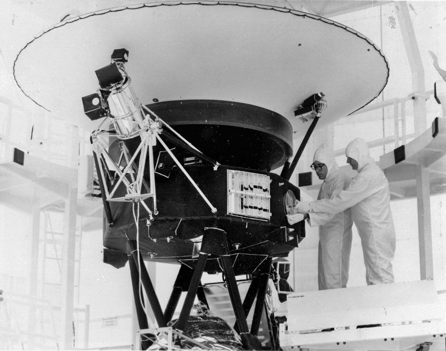 In this Aug. 4, 1977, photo provided by NASA, the "Sounds of Earth" record is mounted on the Voyager 2 spacecraft in the Safe-1 Building at the Kennedy Space Center, Fla., prior to encapsulation in the protective shroud. After days of silence, NASA has heard from Voyager 2, more than 12 billion miles away in interstellar space. Flight controllers accidentally sent a wrong command nearly two weeks ago that tilted the spacecraft's antenna away from Earth and severed contact. The project manager said Tuesday, Aug. 1, 2023 that the fact that the Deep Space Network has picked up a “heartbeat signal” means the 46-year-old craft is alive and operating. (AP Photo/NASA, File)