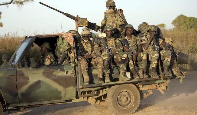 ECOWAS Senegalese troops hold their position in Barra, across from the Gambian capital Banjul Jan. 22, 2017. West Africa&#x27;s regional bloc known as ECOWAS has threatened the use of force in reinstating the president of Niger after he was deposed by his military but how the bloc would carry out the threat remains unclear, with a military deployment on the table. (AP Photo/Jerome Delay, File)