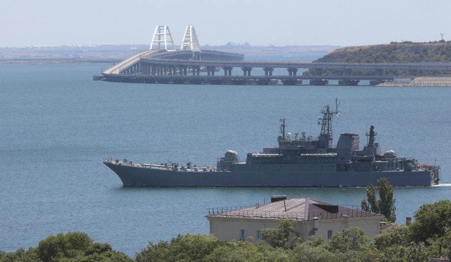 A Russian military landing ship, which now transports cars and people between Crimea and Taman because the Crimean Bridge connecting Russian mainland and Crimean peninsula over the Kerch Strait is closed, sails not far from Kerch, Crimea, on Monday, July 17, 2023. The Crimean Peninsula&#x27;s balmy beaches have been vacation spots for Russian czars and has hosted history-shaking meetings of world leaders. And it has been the site of ethnic persecutions, forced deportations and political repression. Now, as Russia’s war in Ukraine enters its 18th month, the Black Sea peninsula is again both a playground and a battleground. (AP Photo, File)