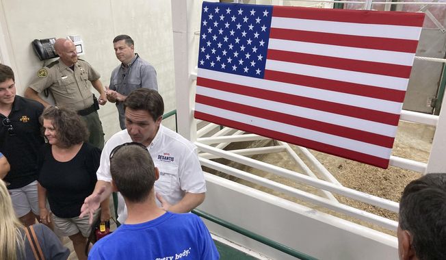Republican presidential candidate Florida Gov. Ron DeSantis greets Iowa Republicans during a campaign stop at Tama Livestock Auction in Tama County, Iowa, Saturday, Aug. 5, 2023. DeSantis was on a two-day trip across Iowa. (AP Photo/Thomas Beaumont)