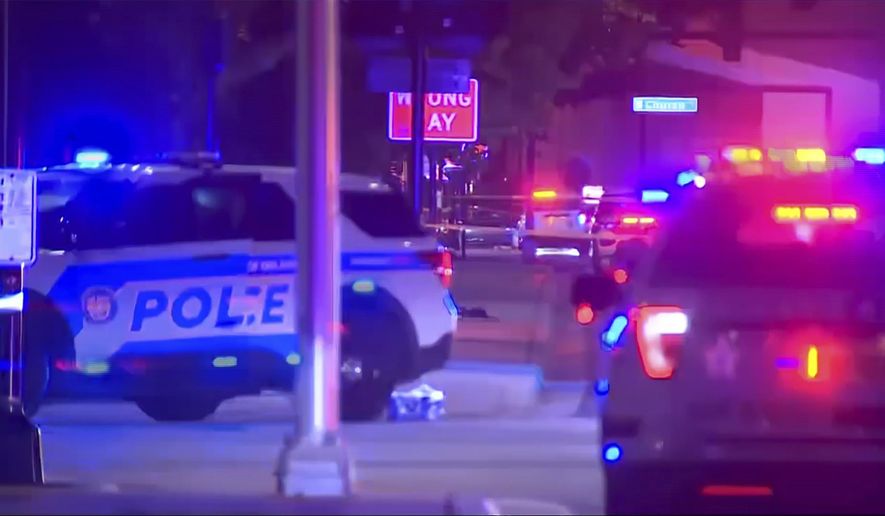 This image from video by WFTV shows emergency vehicles near the site of a shooting that critically injured two police officers on Friday, Aug. 4, 2023, in Orlando, Florida. (WFTV via AP)