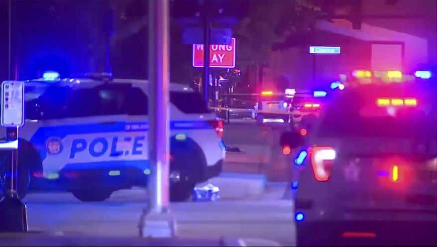 This image from video by WFTV shows emergency vehicles near the site of a shooting that critically injured two police officers on Friday, Aug. 4, 2023, in Orlando, Florida. (WFTV via AP)