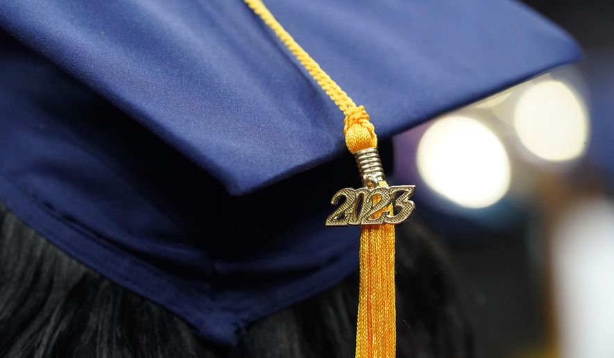A tassel with 2023 on it rests on a graduation cap as students walk in a procession for Howard University&#x27;s commencement in Washington, Saturday, May 13, 2023. (AP Photo/Alex Brandon, File)