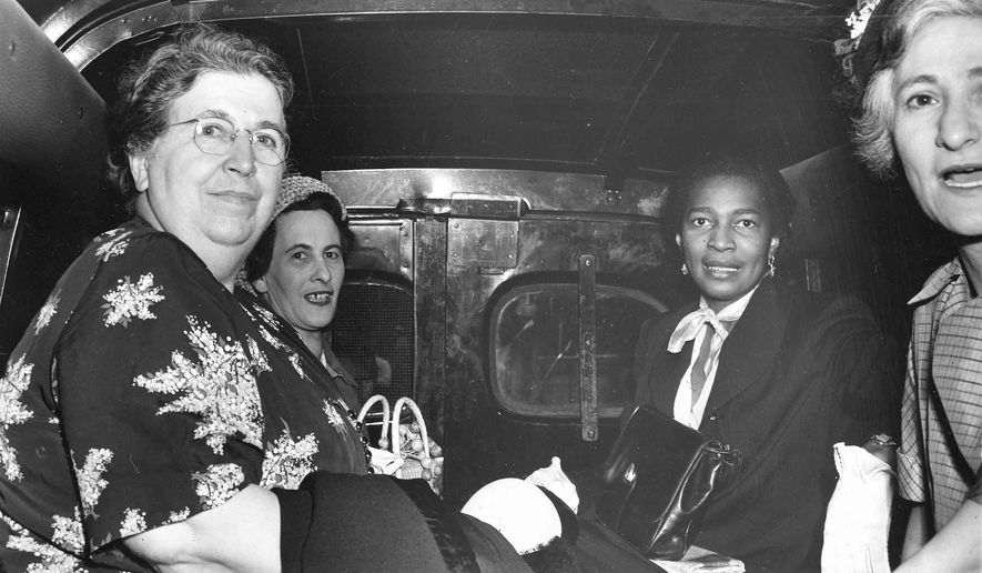 Communist Party members from left; Elizabeth Gurley Flynn, Marion Bachrach, Claudia Jones and Betty Gannett sit calmly in a police van as they leave Federal Court in New York City, June 20, 1951, en route to the Women's House of Detention after arraignment on charges of criminal conspiracy to teach and advocate the overthrow of the government by force and violence. (AP Photo)