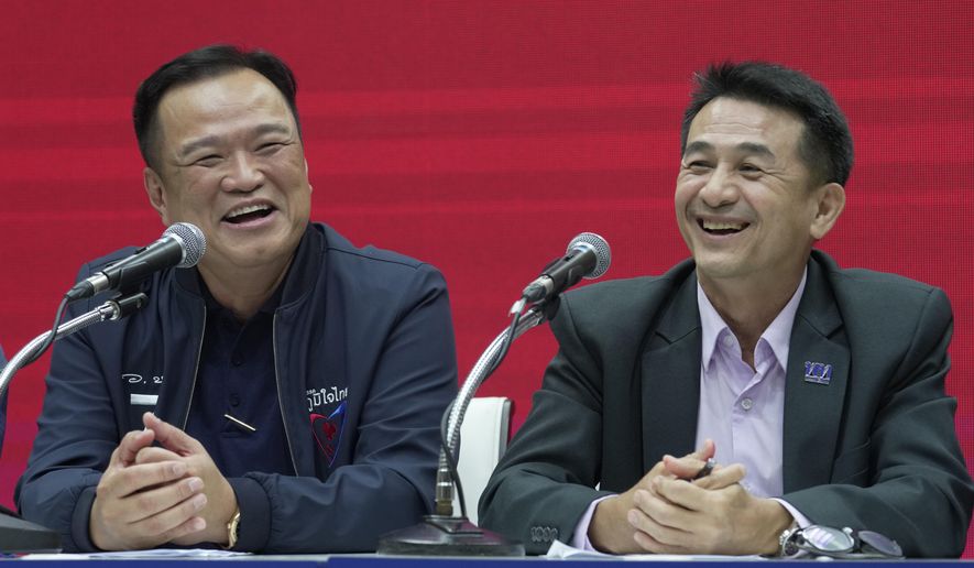 Leader of Bhumjaithai Party Anutin Charnvirakul, left and Leader of Pheu Thai party Chonlanan Srikaew smile during a press conference announcing coalition party at Thai Party headquarters in Bangkok, Thailand, Monday, Aug. 7, 2023. The populist Pheu Thai Party on Monday announced it will assemble a coalition with the Bhumjaithai Party from the outgoing administration to solve the months long political deadlock. (AP Photo/Sakchai Lalit)