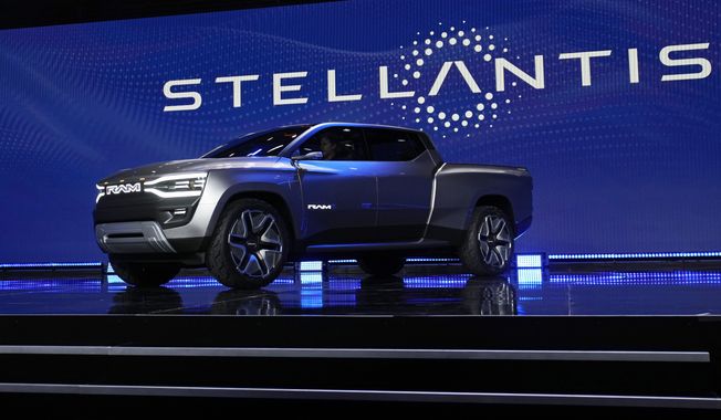 The Ram 1500 Revolution electric battery-powered pickup truck is displayed on stage during the Stellantis keynote at the CES tech show on Jan. 5, 2023, in Las Vegas. Tensions rose in contract talks between the United Auto Workers union and Stellantis on Tuesday, Aug. 8, with the union president accusing the company of seeking concessions in contract talks when the union wants gains, as a September strike threat looms. (AP Photo/John Locher) **FILE**