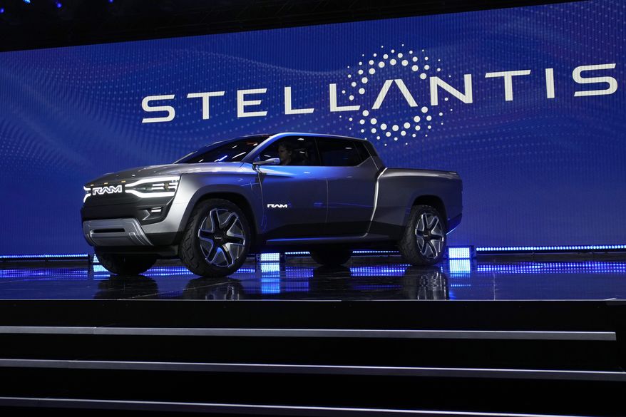 The Ram 1500 Revolution electric battery-powered pickup truck is displayed on stage during the Stellantis keynote at the CES tech show on Jan. 5, 2023, in Las Vegas. Tensions rose in contract talks between the United Auto Workers union and Stellantis on Tuesday, Aug. 8, with the union president accusing the company of seeking concessions in contract talks when the union wants gains, as a September strike threat looms. (AP Photo/John Locher) **FILE**