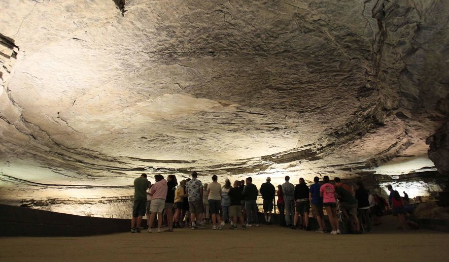 Tourists stand in the rotunda area of Mammoth Cave in Mammoth Cave National Park, Ky., on Aug. 3, 2011. Kentucky's tourism industry bounced back from the COVID-19 pandemic to post its best year on record in 2022, generating an economic impact of nearly $13 billion, the state said Tuesday, Aug. 8, 2023. (AP Photo/Ed Reinke, File)