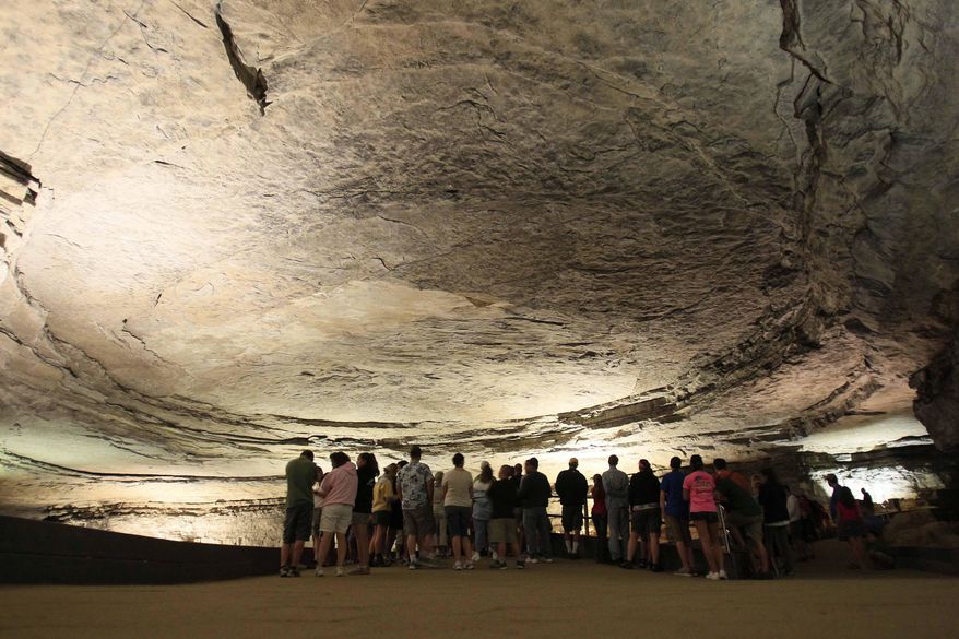 Tourists stand in the rotunda area of Mammoth Cave in Mammoth Cave National Park, Ky., on Aug. 3, 2011. Kentucky's tourism industry bounced back from the COVID-19 pandemic to post its best year on record in 2022, generating an economic impact of nearly $13 billion, the state said Tuesday, Aug. 8, 2023. (AP Photo/Ed Reinke, File)