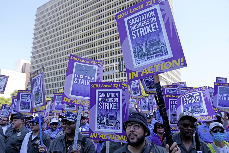 Workers picket outside of City Hall Tuesday, Aug. 8, 2023, in Los Angeles. Thousands of Los Angeles city employees, including sanitation workers, engineers and traffic officers, walked off the job for a 24-hour strike alleging unfair labor practices. The union said its members voted to authorize the walkout because the city has failed to bargain in good faith and also engaged in labor practices that restricted employee and union rights. (AP Photo/Ryan Sun)