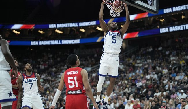 United States&#x27; Mikal Bridges (5) dunks over Puerto Rico&#x27;s Tremont Waters (51) during the first half of an exhibition basketball game Monday, Aug. 7, 2023, in Las Vegas. (AP Photo/John Locher)