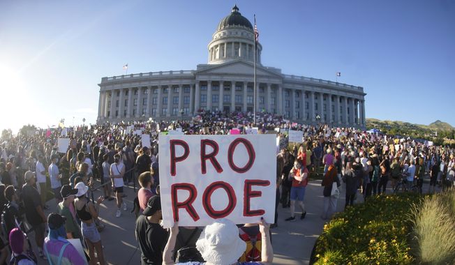 People attend an abortion-rights rally at the Utah State Capitol in Salt Lake City after the U.S. Supreme Court overturned Roe v. Wade, June 24, 2022. State courts in Utah and Kansas are planning to hear arguments Tuesday, Aug. 8, 2023, in legal challenges involving new abortion laws since the overturning of Roe v. Wade. (AP Photo/Rick Bowmer, File)