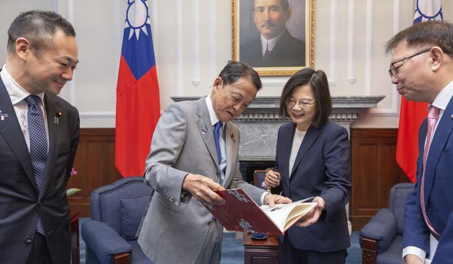In this photo released by the Taiwan Presidential Office, Taiwan&#x27;s President Tsai Ing-wen, center right, chats with Taro Aso, vice president of Japan&#x27;s ruling Liberal Democratic Party during a visit to the Presidential Office in Taipei, Taiwan on Tuesday, Aug. 8, 2023. The senior Japanese politician advocated Tuesday for increasing his country&#x27;s deterrence ability to ensure peace in the region, and called for that message to be clearly conveyed globally — particularly in China. (Taiwan Presidential Office via AP)