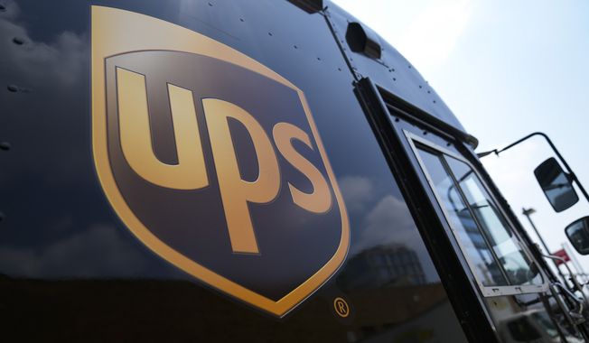 A delivery vehicle sits outside a United Parcel Service facility, Thursday, June 29, 2023, in New York. Revenue declined at UPS in the second quarter and the package delivery company lowered its full-year revenue expectations by $4 billion as package volumes decline, and after reaching a tentative labor contract reached late last month with its 340,000 unionized workers. (AP Photo/John Minchillo)