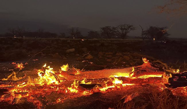 A wildfire burns in Kihei, Hawaii late Wednesday, Aug. 9, 2023. Thousands of residents raced to escape homes on Maui as blazes swept across the island, destroying parts of a centuries-old town in one of the deadliest U.S. wildfires in recent years. (AP Photo/Ty O&#x27;Neil)