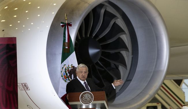 Mexican President Andres Manuel Lopez Obrador gives his daily, morning press conference in front of the former presidential plane at Benito Juarez International Airport in Mexico City, July 27, 2020. Mexico has announced its army-run airline will start up in September 2023, but flight attendants won’t be soldiers. The administration of President Andrés Manuel López Obrador has also put trains, tourism and infrastructure projects under the army&#x27;s command. (AP Photo/Marco Ugarte File)