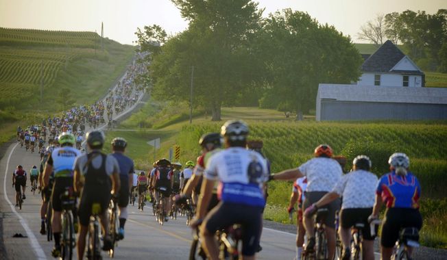 Riders roll out of Tama-Toledo, Iowa, during RAGBRAI 50, Friday, July 28, 2023. (Zach Boyden-Holmes/The Des Moines Register via AP)