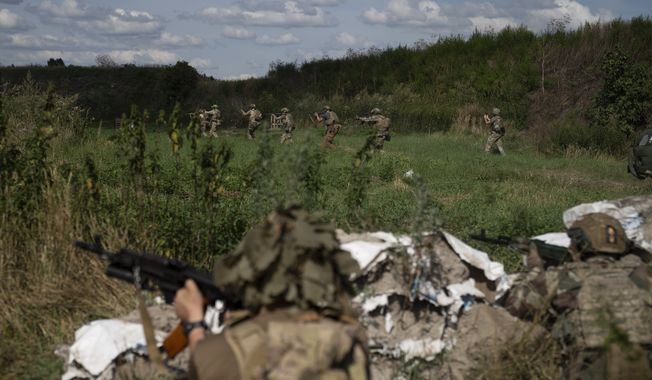 Ukrainian volunteers train for battle at a training ground on the outskirts of Kyiv, Ukraine, Thursday, Aug. 10, 2023. (AP Photo/Bram Janssen)
