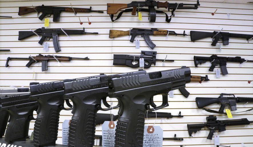 Assault weapons and hand guns are seen for sale at Capitol City Arms Supply on Jan. 16, 2013, in Springfield, Ill. (AP Photo/Seth Perlman, File)