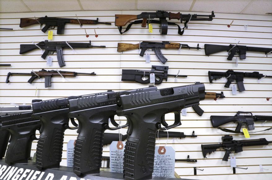 Assault weapons and hand guns are seen for sale at Capitol City Arms Supply on Jan. 16, 2013, in Springfield, Ill. (AP Photo/Seth Perlman, File)
