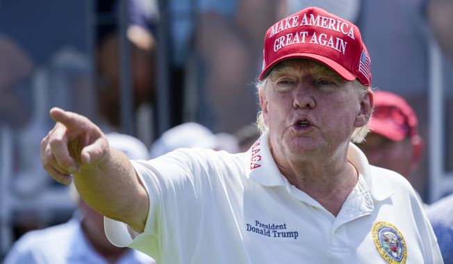 Former President Donald Trump gestures while watching the first round of the Bedminster Invitational LIV Golf tournament in Bedminster, N.J., Friday, Aug. 11, 2023.(AP Photo/Mary Altaffer)