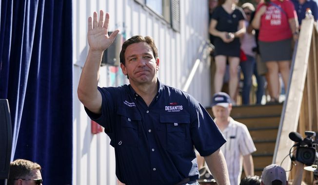 Republican presidential candidate Florida Gov. Ron DeSantis waves as he steps onto the stage for a Fair-Side Chat with Iowa Gov. Kim Reynolds at the Iowa State Fair, Saturday, Aug. 12, 2023, in Des Moines, Iowa. (AP Photo/Jeff Roberson)