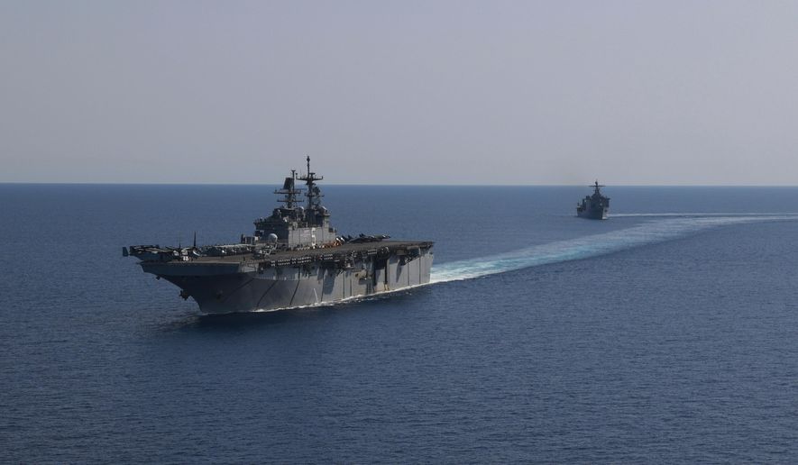 In this photo released by the U.S. Navy, the amphibious assault ship USS Bataan, front, and the landing ship USS Carter Hall, back travel through the Red Sea, Tuesday, Aug. 8, 2023. (Mass Communication Specialist 3rd Class Riley Gasdia/U.S. Navy, via AP) ** FILE **