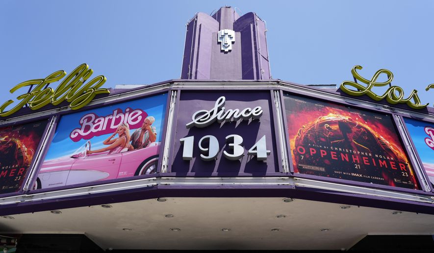 The marquee of the Los Feliz Theatre features the films "Barbie" and "Oppenheimer," Friday, July 28, 2023, in Los Angeles. (AP Photo/Chris Pizzello)