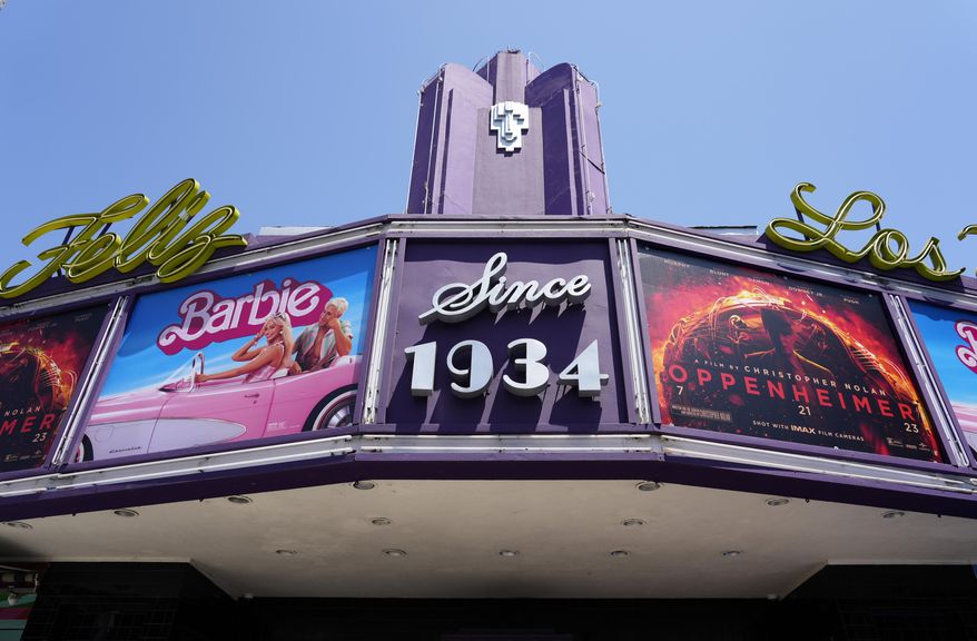 The marquee of the Los Feliz Theatre features the films "Barbie" and "Oppenheimer," Friday, July 28, 2023, in Los Angeles. (AP Photo/Chris Pizzello)