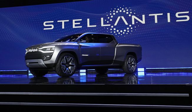 The Ram 1500 Revolution electric battery-powered pickup truck is displayed on stage during the Stellantis keynote at the CES tech show on Jan. 5, 2023, in Las Vegas. Tensions rose in contract talks between the United Auto Workers union and Stellantis on Tuesday, Aug. 8, with the union president accusing the company of seeking concessions in contract talks when the union wants gains, as a September strike threat looms. (AP Photo/John Locher, File)