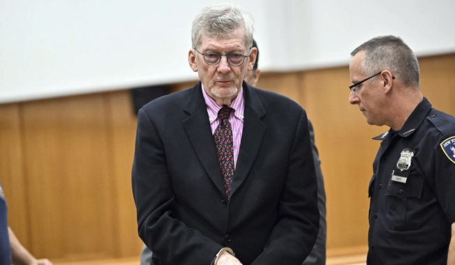 Lawrence Gray, center, a retired political science professor, is handcuffed as he appears at his arraignment in Manhattan criminal court, Tuesday, Aug. 15, 2023, in New York. Gray, 79, pleaded not guilty Tuesday to charges that he stole rare and valuable pieces that included diamond earrings, a pink sapphire brooch, and a 19th-century gold pocket watch. (Curtis Means/Daily Mail via AP)