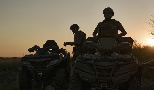 Ukrainian soldiers ride all-terrain vehicles at the front line near Bakhmut, one of the longest battles with Russian troops, Ukraine, Monday, Aug. 14, 2023. (AP Photo/Libkos)