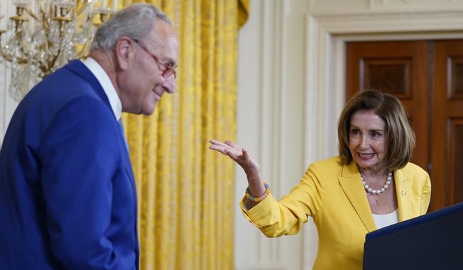 Former Speaker of the House Nancy Pelosi, D-Calif., looks to Senate Majority Leader Chuck Schumer, D-N.Y., as she speaks on the anniversary of the Inflation Reduction Act during an event in the East Room of the White House, Wednesday, Aug. 16, 2023, in Washington. (AP Photo/Evan Vucci)