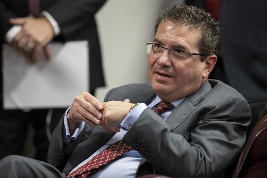 Then-Washington Redskins owner Dan Snyder listens to head coach Ron Rivera during a news conference at the team's NFL football training facility, in Ashburn, Va., Jan. 2, 2020. (AP Photo/Alex Brandon, File)