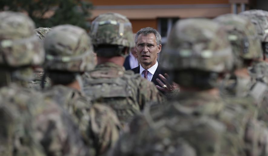 NATO Secretary-General Jens Stoltenberg talks to U.S. army soldiers while visiting Prague, Czech Republic, on Sept. 9, 2015. The Czech Republic has completed the ratification of a defense treaty with the United States that deepens military cooperation and makes it easier to deploy U.S. troops on Czech territory. Czech Prime Minister Petr Fiala's signature on Wednesday, Aug. 16, 2023, was the final step in the ratification process of the Defense Cooperation Agreement. (AP Photo/Petr David Josek, File)
