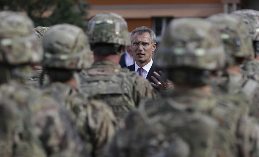 NATO Secretary-General Jens Stoltenberg talks to U.S. army soldiers while visiting Prague, Czech Republic, on Sept. 9, 2015. The Czech Republic has completed the ratification of a defense treaty with the United States that deepens military cooperation and makes it easier to deploy U.S. troops on Czech territory. Czech Prime Minister Petr Fiala's signature on Wednesday, Aug. 16, 2023, was the final step in the ratification process of the Defense Cooperation Agreement. (AP Photo/Petr David Josek, File)
