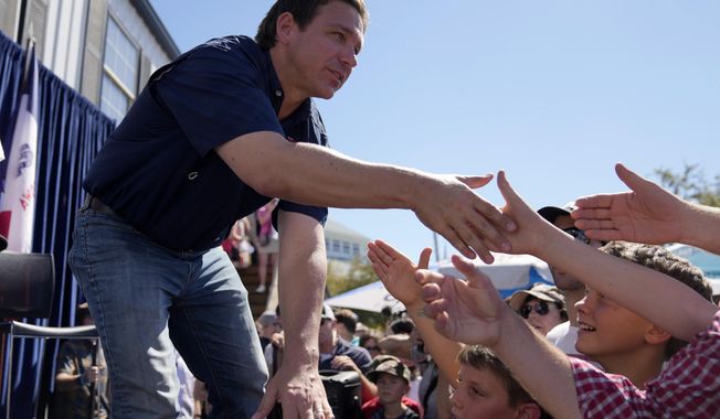 Republican presidential candidate Florida Gov. Ron DeSantis shakes hands with fairgoers after taking part in a Fair-Side Chat with Iowa Gov. Kim Reynolds at the Iowa State Fair, Saturday, Aug. 12, 2023, in Des Moines, Iowa. (AP Photo/Jeff Roberson)
