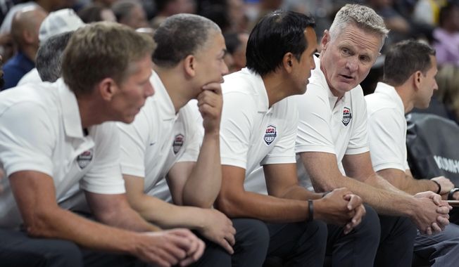 United States head coach Steve Kerr, fourth from left, speaks with assistant coach Erik Spoelstra, third from left, during the first half of an exhibition basketball game against Puerto Rico, Monday, Aug. 7, 2023, in Las Vegas. (AP Photo/John Locher)