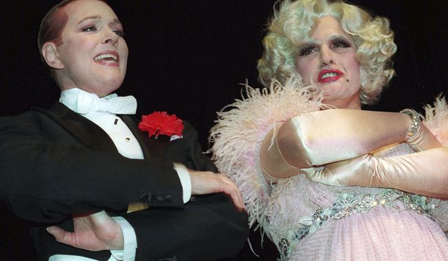 FILE — New York Mayor Rudolph Giuliani, right, dressed in drag as a role in &quot;Victor/Victoria,&quot; sings with Julie Andrews at the New York Hilton, March 1, 1997, during an event presented by the Inner Circle. Giuliani, once warmly regarded as &quot;America&#x27;s Mayor&quot; in the wake of the 9/11 attacks, and who first rose to prominence as a federal prosecutor going after mobsters with a then-novel approach to racketeering cases, has seen his reputation tumble and his liberty threatened in defense of Donald Trump&#x27;s bogus election fraud claims. (AP Photo/Joe DeMaria, File)